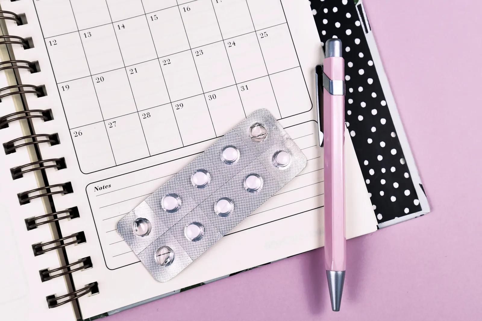 Planner calendar next to a blister pack of pills